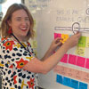 Smiling woman working with post-it notes